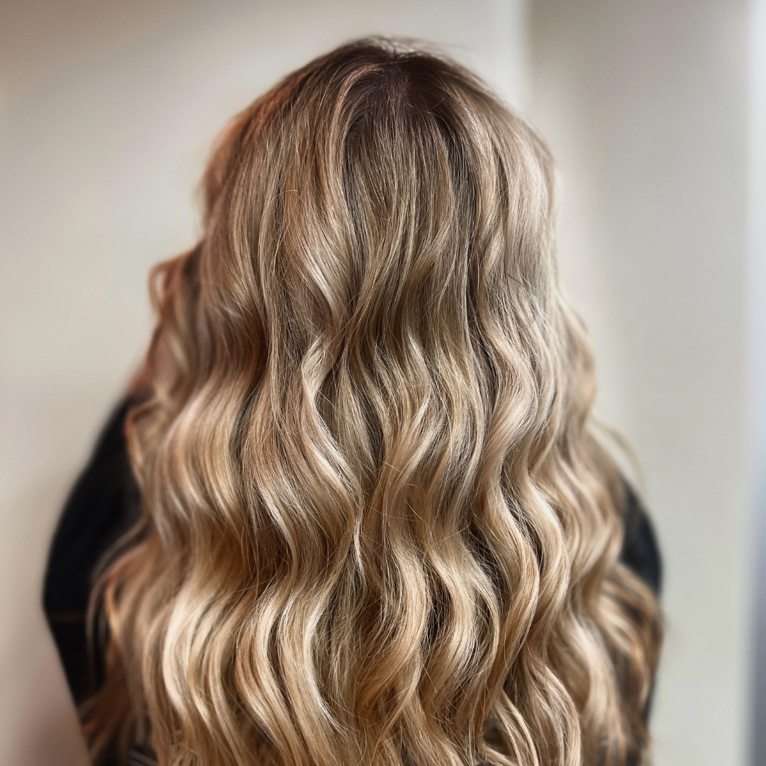 The after look of a blonde hair color and style appointment at Hair Loft Salon